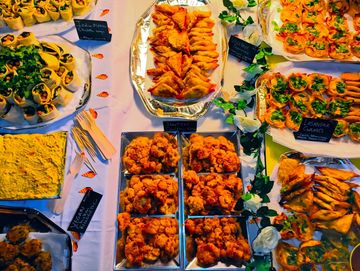 A colorful spread of vegan and vegetarian appetizers on a decorated table.