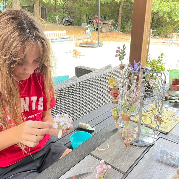 Girl creating floral bouquet for oil diffuser