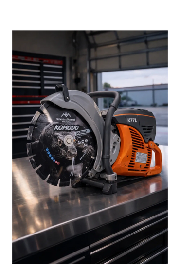 A Komodo asphalt cutting saw with a detailed lizard design on the blade.