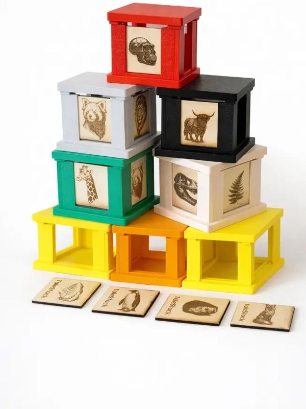 Colorful wooden blocks with animal and skull engravings, arranged in a pyramid.