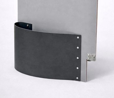 Black curved metal piece attached to a gray panel with screws.