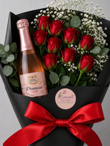 Bouquet of red roses with a bottle of Prosecco rosé, wrapped in black paper with a red ribbon.