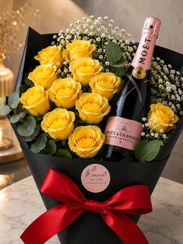 A bouquet of yellow roses with a bottle of Moët & Chandon champagne.