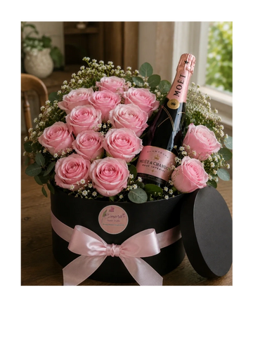 Elegant bouquet of pink roses with a bottle of Moët champagne in a black gift box.