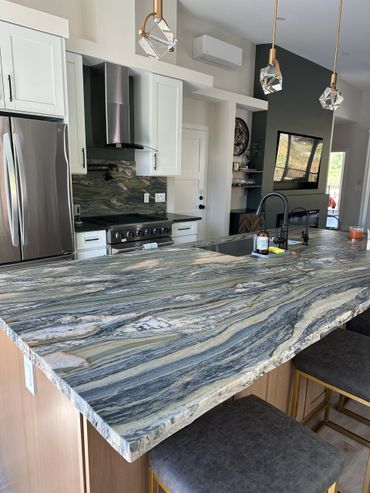 Green fusion quartzite backsplash and island with soapstone 3cm perimeter done by Custom Slab Works
