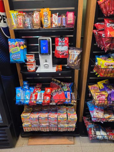 Self-service micro market with modern touchscreen checkout providing fresh food, snacks, beverages,