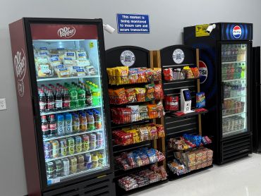 Cashless snack and beverage vending machines installed in a warehouse break room, providing employee