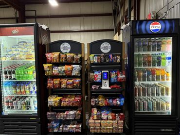 Cashless snack and beverage vending machines installed in a warehouse break room, providing employee