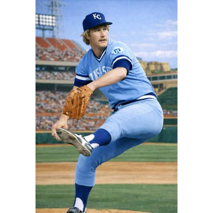 Baseball pitcher in Kansas City Royals uniform mid-pitch on the mound.