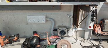 Workshop power outlets and various power tools on a workbench.