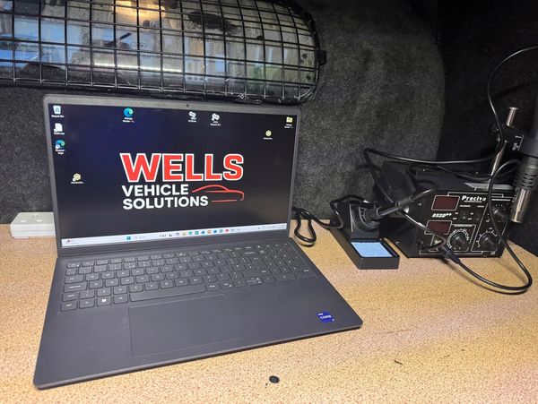 Laptop with Wells Vehicle Solutions logo next to a Preciva soldering station.