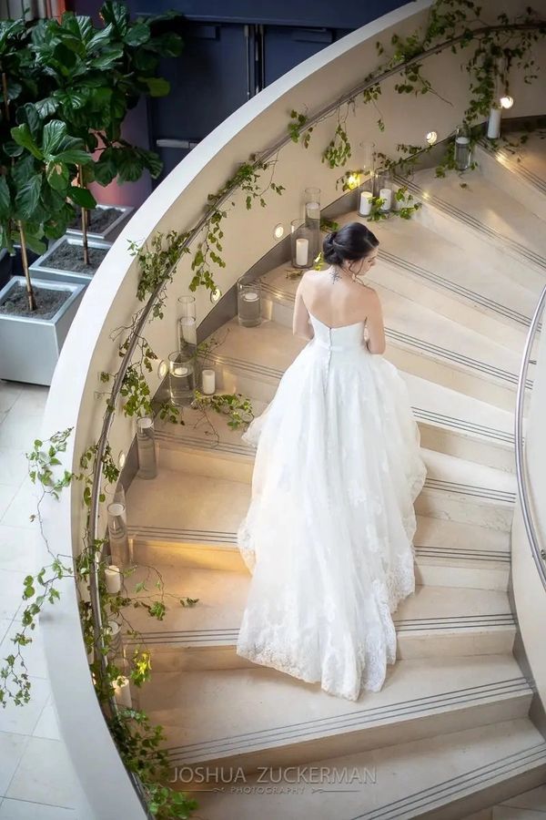 Wedding dress shopping may be needed in an upcoming book - here is a bride ascending the staircase