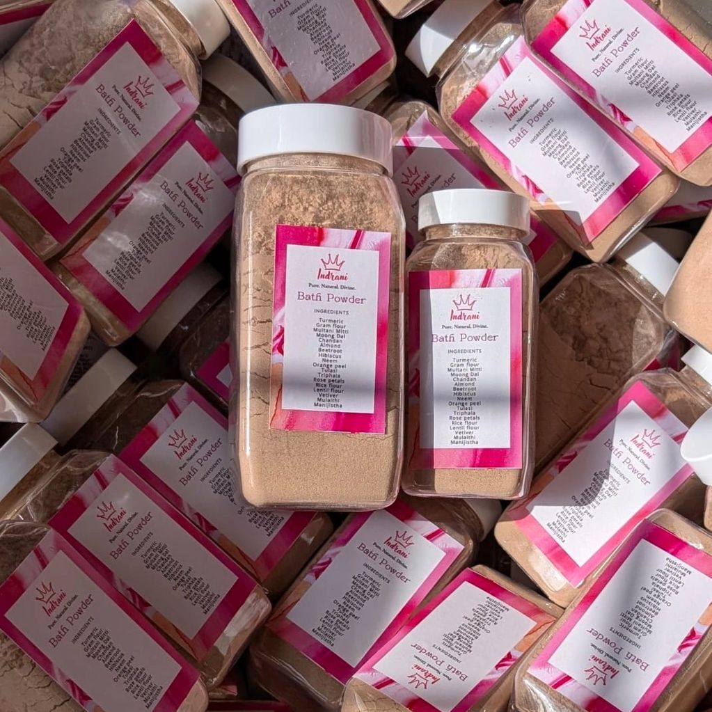 Multiple bottles of Indrani Batfi Powder with pink labels.