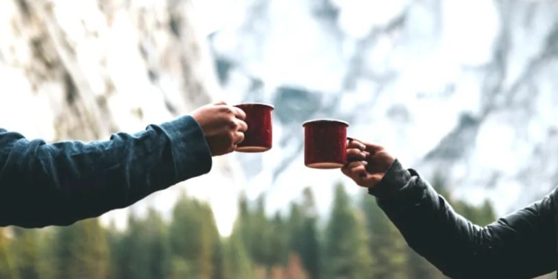 Two people holding mugs