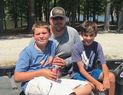 Caleb Speight (left) and Tyler Baker (right) with the dedicated boat captain, Drew Collins.