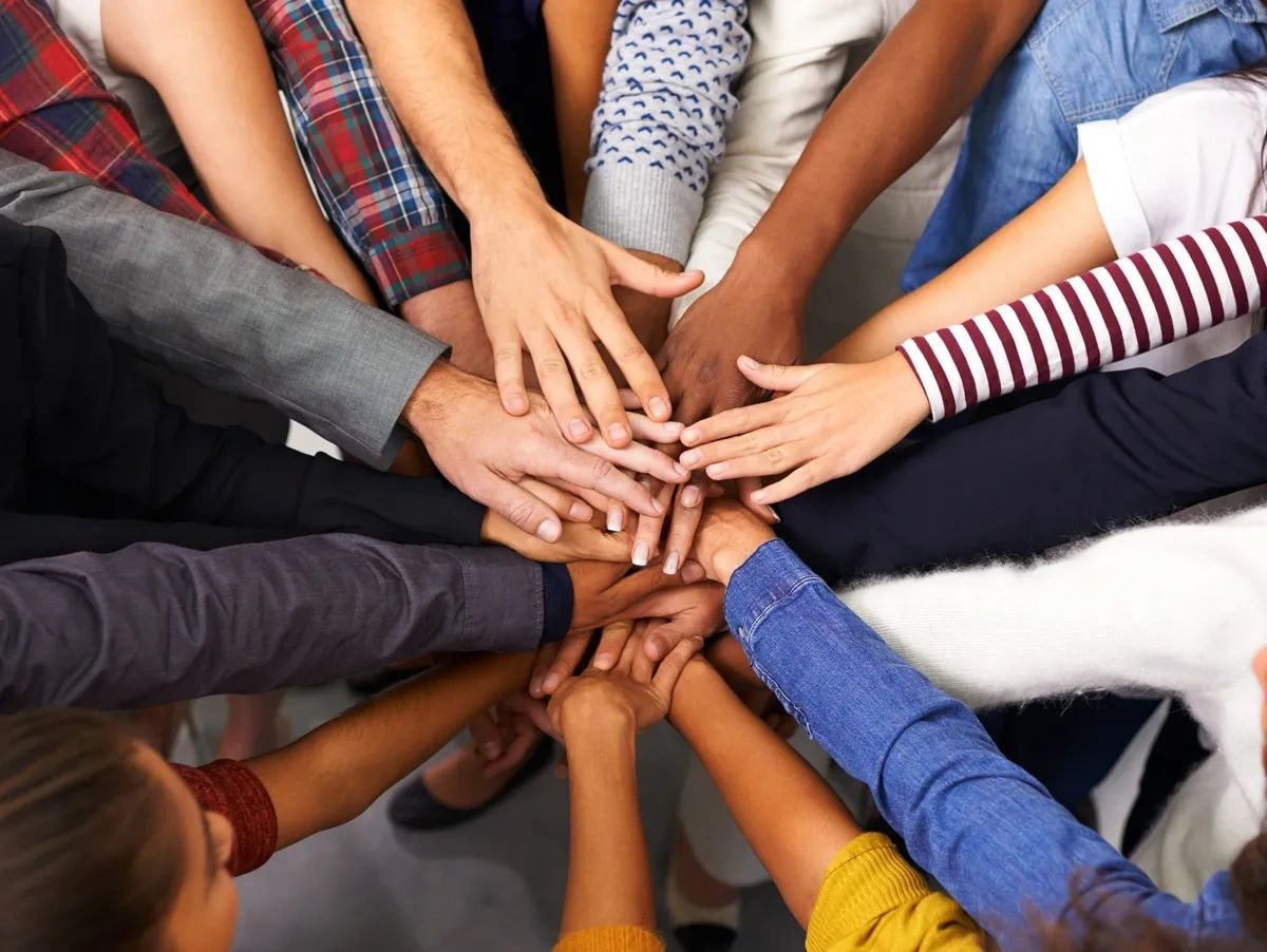 Circle of multicultural hands all holding each other