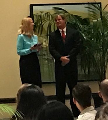 Dr. Mercer giving Bradley Williamson an award for leadership in Biotechnology