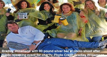 Bradley Williamson at a photo shoot with an 80-pound silver bar from a shipwreck.