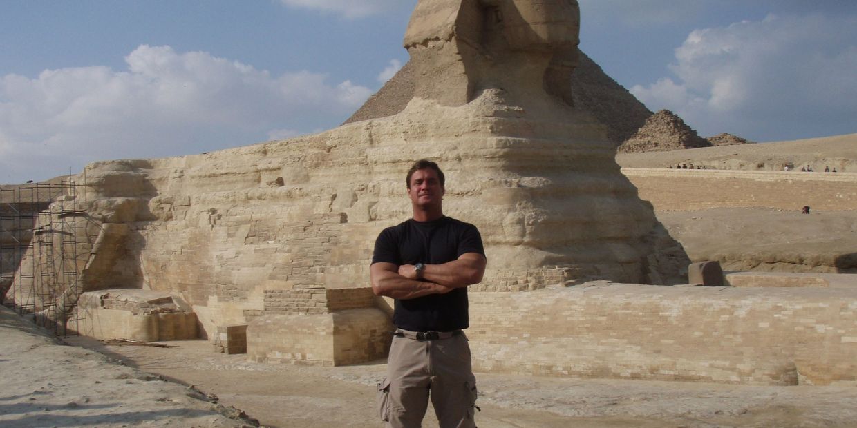 Bradley Williamson in front of Sphinx and Great Pyramid on Giza plateau in Egypt.