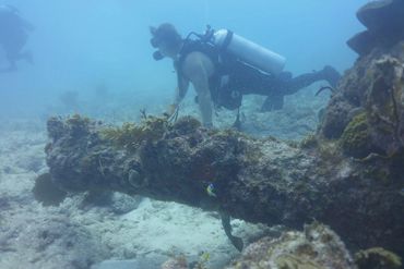 Bradley Williamson with under water cannon at shipwreck site