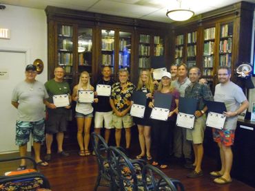 Some of our students in classroom with graduation certificates