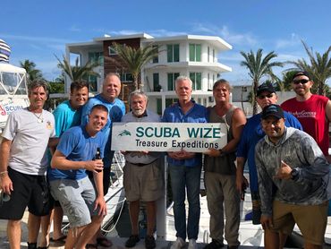 One of our classes celebrating graduation after finishing their dives on sunken treasure sites.