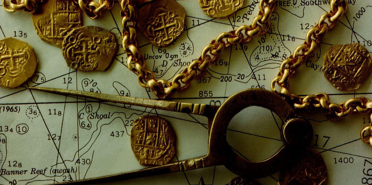 Treasure map with gold doubloons and gold chain