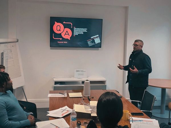 Man presenting to a group in a meeting room.