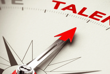 Compass pointing towards the word 'TALENT' in bold red letters.