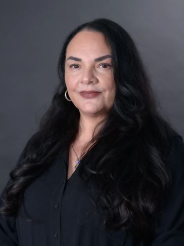 Woman with long black hair in a black shirt.
