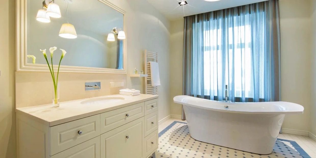 Elegant bathroom with freestanding bathtub and vanity.