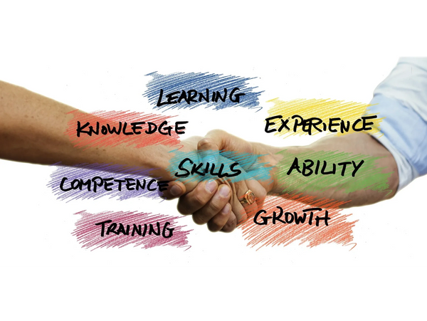Handshake surrounded by words like learning, skills, and growth symbolizing collaboration and development.