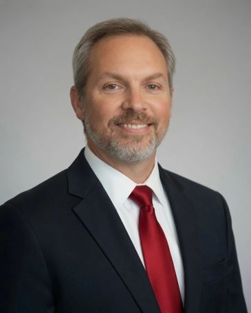 Professional man in suit with red tie.