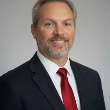 Professional man in suit with red tie.