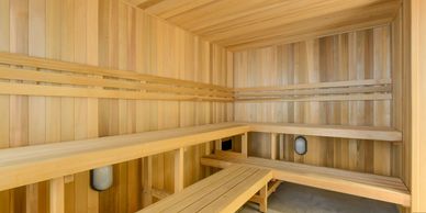 Interior of a wooden sauna with bench seating on two sides.