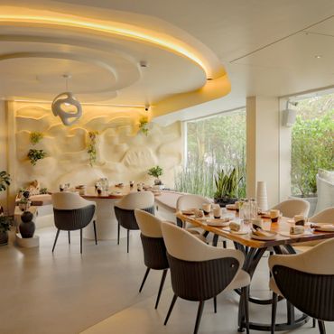 Modern restaurant interior with elegant seating and ambient lighting.