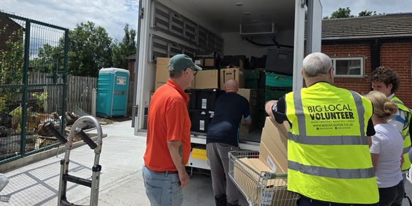 Volunteers unloading supplies from a truck.
