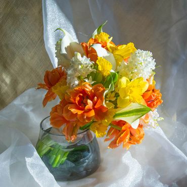 Spring seasonal: tulips, daffodil, hyacinth, and calla lilies.