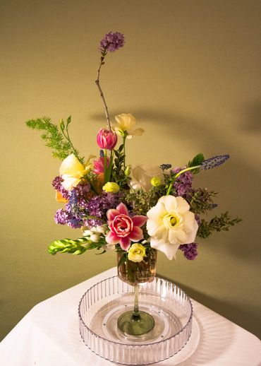 A Easter bouquet, served on a beautiful pink and green glass.