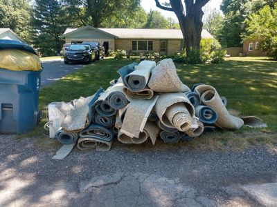 Pile of junk carpet on the side of road 