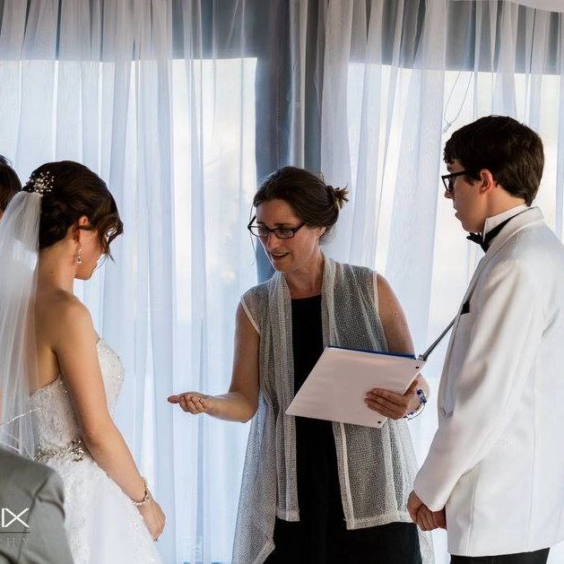 Rev. Erin Goodman with bride and groom during wedding ceremony at Waterman Grill in Providence RI.