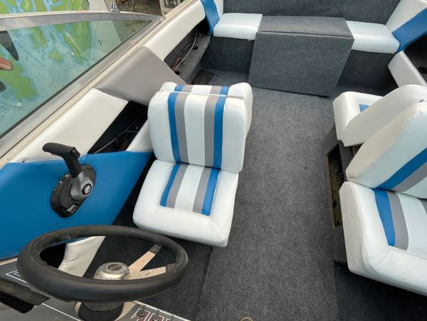 Blue, white, and gray upholstered boat seats by Divine Impact LLC, expert marine upholstery services