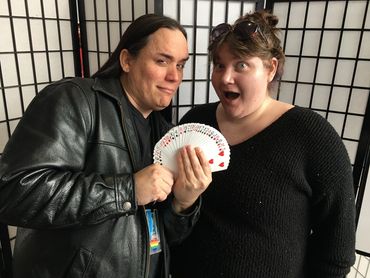 MVC Magic Club faculty co-sponsor demonstrates a magical card reveal to Courtney.