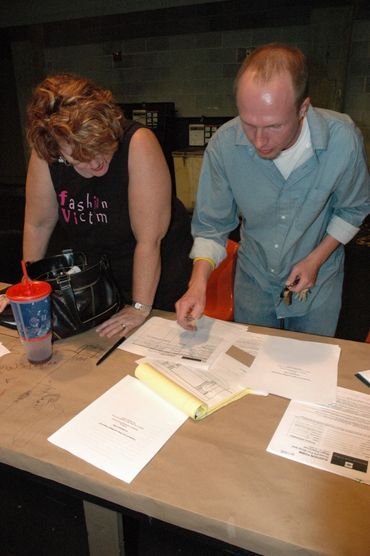 Theater director Nathan Cole reviews promotional materials for "Howard's Fun Shop and Magic Emporium