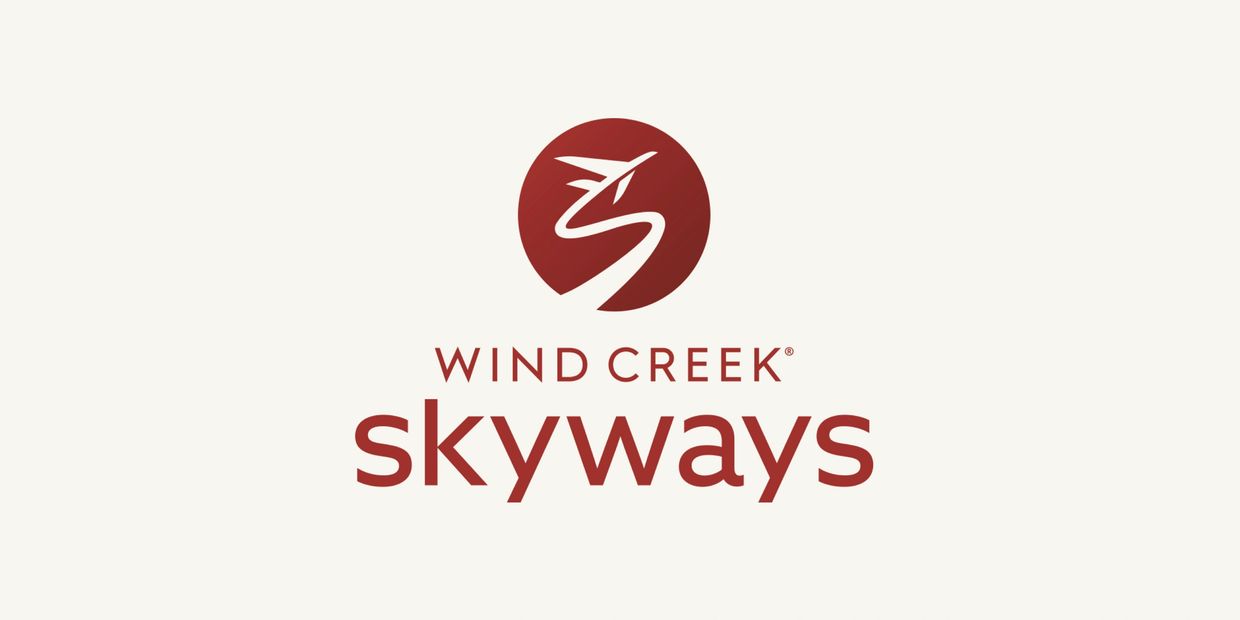 Wind Creek Skyways logo with a stylized plane and pathway in red.