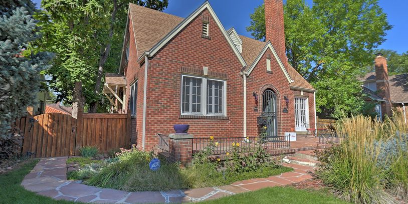 Exterior shot of a historic Tudor-style home and manicured yard