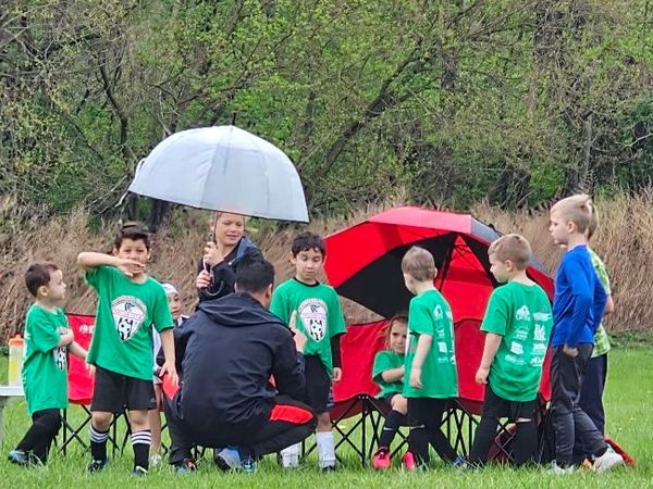 SV kids soccer huddle on a rainy day