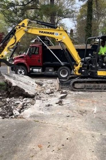 excavator and dump truck used for disposal of raw materials.