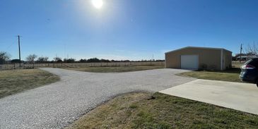 gravel driveway reconditioned and compacted by phillips skid steering