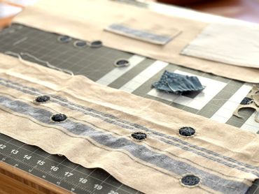 Pieces of the french stripe linen tote in work.